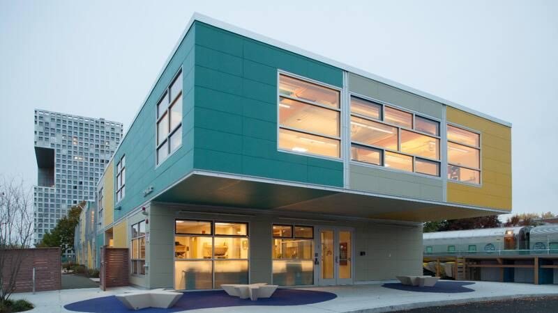 Community activity building - covered entry plaza and outdoor seating